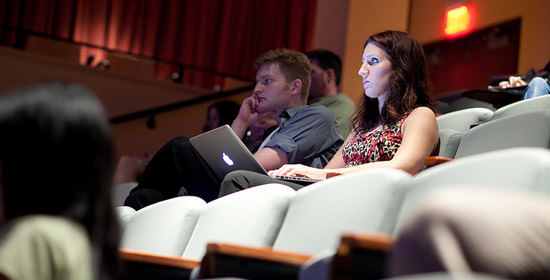 Freelancer working on a laptop in a lecture hall