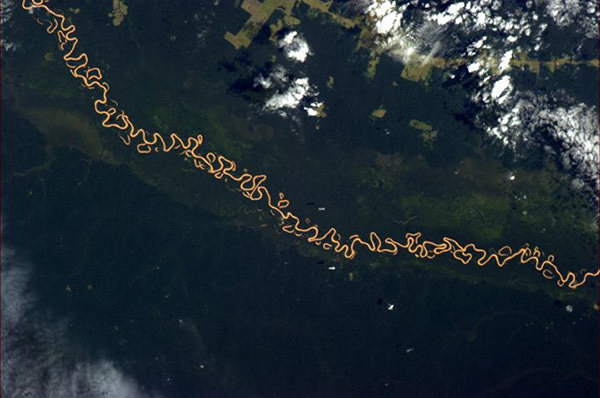 Winding river in Bolivia illuminated by sunlight